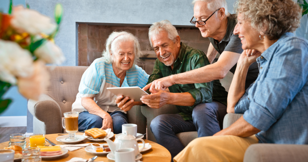 Group of seniors looking at digital tablet